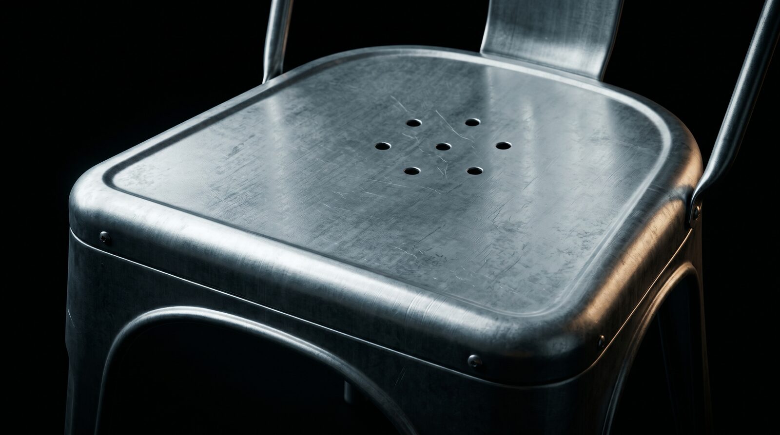 Macro photograph of the rolled steel lip of the Tolix Model A seat